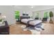 Comfortable bedroom featuring wood floors, a large bed, and picturesque views of the green outdoors at 230 Deer Forest Rd, Fayetteville, GA 30214