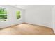Bright bedroom featuring light wood flooring, white walls, and natural light from large windows at 230 Deer Forest Rd, Fayetteville, GA 30214