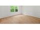 Bright bedroom features new laminate flooring and a large window with treed view at 230 Deer Forest Rd, Fayetteville, GA 30214
