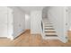 Inviting entryway with wood floors and stairs with white risers and black metal spindles at 230 Deer Forest Rd, Fayetteville, GA 30214