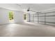 Spacious garage with roll up door, light walls, and windows for natural light at 230 Deer Forest Rd, Fayetteville, GA 30214