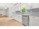 Bright kitchen features white cabinets, stainless steel appliances, and a large window view at 230 Deer Forest Rd, Fayetteville, GA 30214