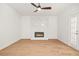 Unfurnished living room boasts wood floors, a fireplace, and ample natural light at 230 Deer Forest Rd, Fayetteville, GA 30214
