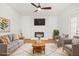 Bright living room features a decorative fireplace, wood floors, and modern furniture at 230 Deer Forest Rd, Fayetteville, GA 30214
