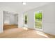 Bright living room featuring white walls, new laminate floors, and multiple windows at 230 Deer Forest Rd, Fayetteville, GA 30214