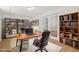 Home office with hardwood floors, built-in bookshelves, and natural light at 230 Deer Forest Rd, Fayetteville, GA 30214