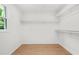 Walk-in closet featuring wood floors and white shelving providing plenty of storage space at 230 Deer Forest Rd, Fayetteville, GA 30214