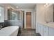 Sleek bathroom featuring a glass shower and a modern soaking tub by a bright window at 322 Delta Dr, Mcdonough, GA 30253