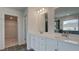 Bright bathroom featuring and sinks with vanity and view into closet at 322 Delta Dr, Mcdonough, GA 30253