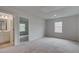 Neutral bedroom with carpet, a window for natural light, and an ensuite bathroom entrance at 322 Delta Dr, Mcdonough, GA 30253