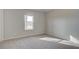 Bedroom with neutral carpeting and a window providing lots of natural light at 322 Delta Dr, Mcdonough, GA 30253