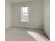 Bedroom with neutral carpeting and a window, providing a simple and cozy space at 322 Delta Dr, Mcdonough, GA 30253