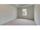 Carpeted bedroom featuring natural light from a window and a tray ceiling at 322 Delta Dr, Mcdonough, GA 30253