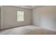 Carpeted bedroom featuring natural light from a window and white trim at 322 Delta Dr, Mcdonough, GA 30253
