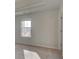 Bedroom featuring a window and neutral carpet providing lots of natural light at 322 Delta Dr, Mcdonough, GA 30253