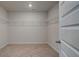 Walk-in closet with white wire shelving and plush carpeting at 322 Delta Dr, Mcdonough, GA 30253