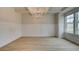 Dining room featuring elegant wainscoting, tray ceiling, and a stylish chandelier at 322 Delta Dr, Mcdonough, GA 30253