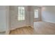 Bright entryway with light wood floors and white trim, showcasing a welcoming front door at 322 Delta Dr, Mcdonough, GA 30253