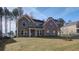 Well-maintained brick home with a lush green lawn, offering a timeless and inviting curb appeal at 322 Delta Dr, Mcdonough, GA 30253