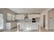 Well-lit kitchen features quartz counters, stainless appliances, and an island at 322 Delta Dr, Mcdonough, GA 30253