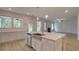 Open kitchen with a center island, stainless steel dishwasher, and view into living room with fireplace at 322 Delta Dr, Mcdonough, GA 30253