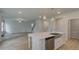 Open-concept kitchen with a center island, stainless steel appliances, and view into the connected living area at 322 Delta Dr, Mcdonough, GA 30253