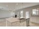 Modern kitchen with island counter overlooking living room with fireplace at 322 Delta Dr, Mcdonough, GA 30253