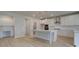 Spacious kitchen boasts a large center island with white cabinets, stainless steel appliances, and modern pendant lighting at 322 Delta Dr, Mcdonough, GA 30253