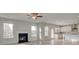 Open-concept living room with fireplace flows seamlessly into modern kitchen at 322 Delta Dr, Mcdonough, GA 30253