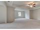 Spacious main bedroom featuring tray ceiling, ceiling fan, and neutral carpeting at 322 Delta Dr, Mcdonough, GA 30253