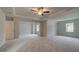 Large main bedroom with tray ceiling, plush carpeting, and lots of natural light at 322 Delta Dr, Mcdonough, GA 30253