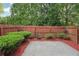 Cozy backyard area with a concrete patio and lush greenery, perfect for outdoor entertaining at 6071 Apple Grove Rd, Buford, GA 30519