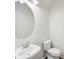 Clean and modern half bathroom with a pedestal sink and a toilet at 6071 Apple Grove Rd, Buford, GA 30519