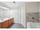 Elegant bathroom with double vanity, tiled tub, and modern fixtures providing a luxurious feel at 6071 Apple Grove Rd, Buford, GA 30519