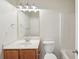 Cozy bathroom with a light wood vanity, a mirror, and toilet at 6071 Apple Grove Rd, Buford, GA 30519