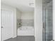 Chic bathroom with sleek shower and tiled tub, offering a clean and contemporary design at 6071 Apple Grove Rd, Buford, GA 30519