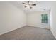 Cozy bedroom featuring neutral carpet, ceiling fan and a bright window at 6071 Apple Grove Rd, Buford, GA 30519