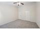Large bedroom featuring neutral carpet, ceiling fan and two doors at 6071 Apple Grove Rd, Buford, GA 30519
