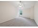 Comfortable bedroom featuring a neutral carpet, ceiling fan and a bright window at 6071 Apple Grove Rd, Buford, GA 30519