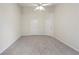 Large bedroom featuring neutral carpet, ceiling fan and two doors at 6071 Apple Grove Rd, Buford, GA 30519