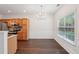 Dining area featuring a modern chandelier, hardwood floors, and a large window at 6071 Apple Grove Rd, Buford, GA 30519