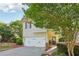 Attractive home with a welcoming front door and lush greenery surrounding the property at 6071 Apple Grove Rd, Buford, GA 30519