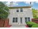 Back of the house with a small patio and fenced yard, showcasing the home's outdoor space at 6071 Apple Grove Rd, Buford, GA 30519