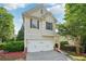 Charming home featuring a two-car garage and well-maintained landscaping at 6071 Apple Grove Rd, Buford, GA 30519