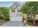 Charming two-story home with a well-manicured lawn, attached garage, and inviting front porch at 6071 Apple Grove Rd, Buford, GA 30519