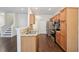 Well-lit kitchen featuring stainless steel appliances, light wood cabinets, and granite countertops at 6071 Apple Grove Rd, Buford, GA 30519