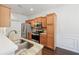 Well-lit kitchen featuring stainless steel appliances, light wood cabinets, and granite countertops at 6071 Apple Grove Rd, Buford, GA 30519
