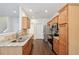 Well-lit kitchen featuring stainless steel appliances, light wood cabinets, and granite countertops at 6071 Apple Grove Rd, Buford, GA 30519