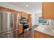 Bright kitchen featuring stainless steel appliances, light wood cabinets, and an adjacent dining area at 6071 Apple Grove Rd, Buford, GA 30519