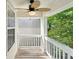 Inviting porch with a ceiling fan and white railings, perfect for enjoying the outdoors at 6071 Apple Grove Rd, Buford, GA 30519